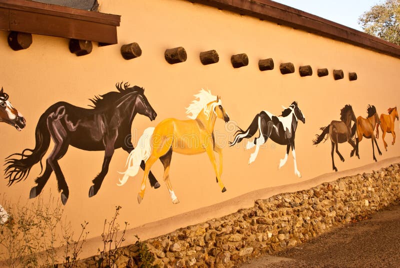 TAOS, NEW MEXICO/USA - OCTOBER 20: Mural depicting wild painted horses on walls of old town shown on October 20, 2011 in Taos, New Mexico. Taos is world famous for arts and culture. TAOS, NEW MEXICO/USA - OCTOBER 20: Mural depicting wild painted horses on walls of old town shown on October 20, 2011 in Taos, New Mexico. Taos is world famous for arts and culture.