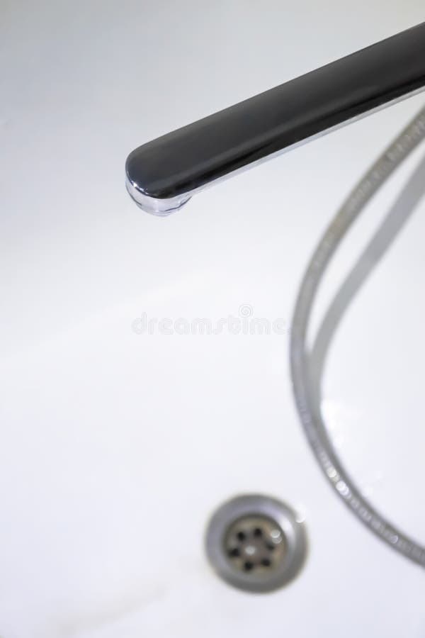 Tap in the White Bathroom Opposite the Drain for Water. Drain at the