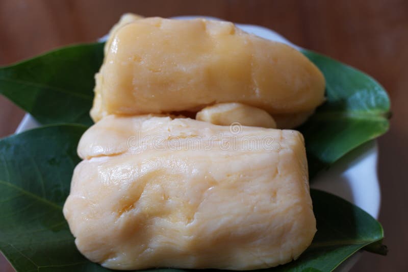 Tapai or Tape or Peuyeum are traditional food snack from indonesia, made from fermented cassava. Served on leaf in plate, stock photo. Tapai or Tape or Peuyeum are traditional food snack from indonesia, made from fermented cassava. Served on leaf in plate, stock photo.