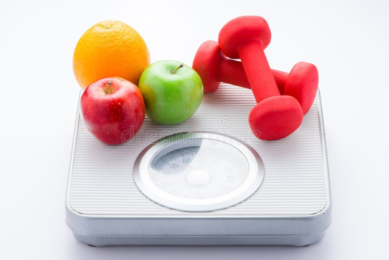 Tape measure on bathroom scale for weight of human body, dumbbells for fitness and fresh fruits. Concept of healthy lifestyle and. Slimming stock photography Tape measure on bathroom scale for weight of human body, dumbbells for fitness and fresh fruits. Concept of healthy lifestyle and. Slimming stock photography
