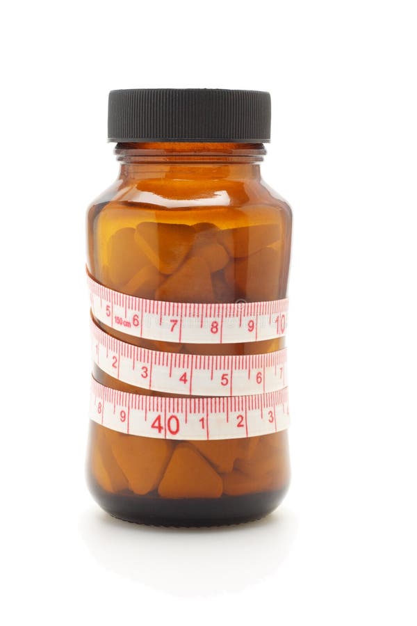 Tape measure and diet pills in glass bottle