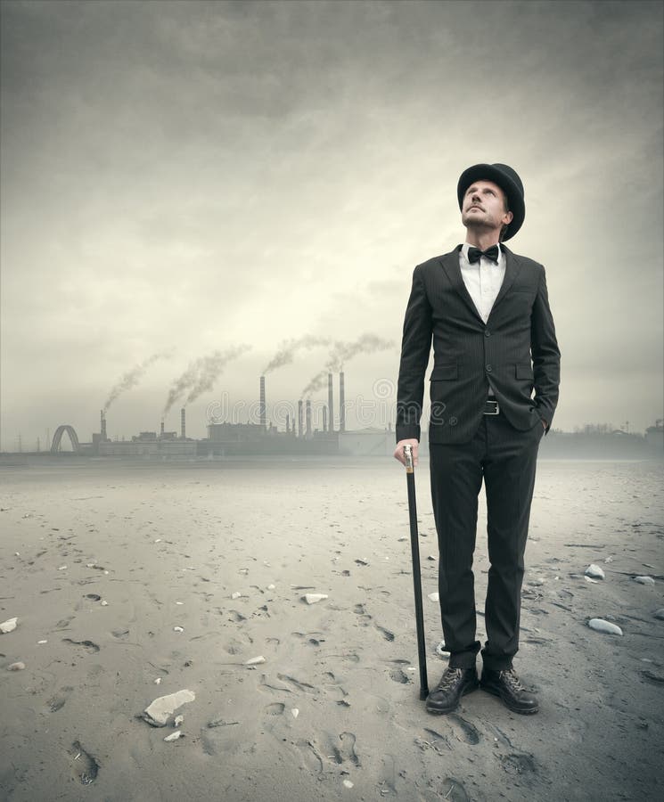 Vintage businessman looking away with polluting factory and post atomic landscape on background. Vintage businessman looking away with polluting factory and post atomic landscape on background.