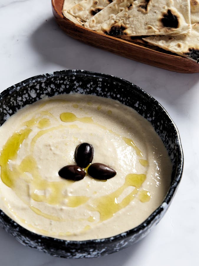 Taramasalata in the bowl with olive oil and black olive. Taramasalata is a Greek spread and meze made from tarama, the royalty free stock photography Taramasalata in the bowl with olive oil and black olive. Taramasalata is a Greek spread and meze made from tarama, the royalty free stock photography