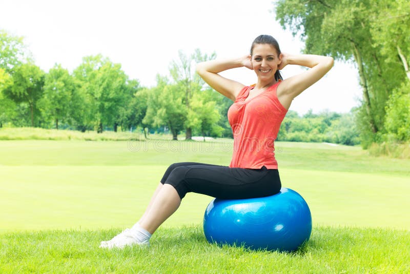 Fitness women exercising with pilates ball outdoors. Fitness women exercising with pilates ball outdoors.
