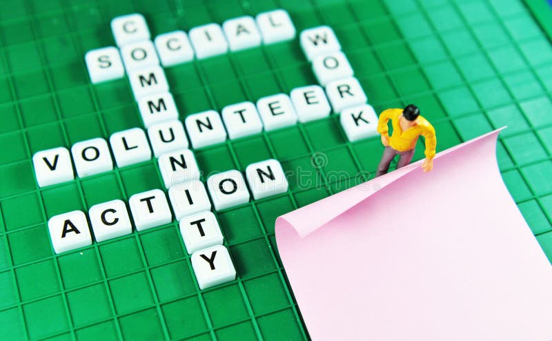 Volunteer key words on game boards and miniature people holding blank post-it. Volunteer key words on game boards and miniature people holding blank post-it