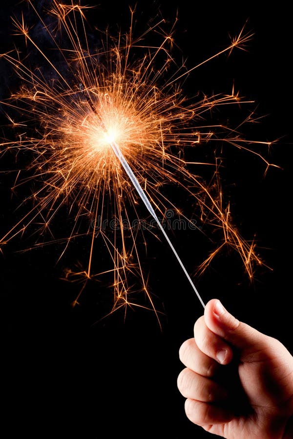 TARGET313_1_ płonącego sparkler dziecko ręka. fotografia stock TARGET313_1_ płonącego sparkler dziecko ręka. fotografia stock