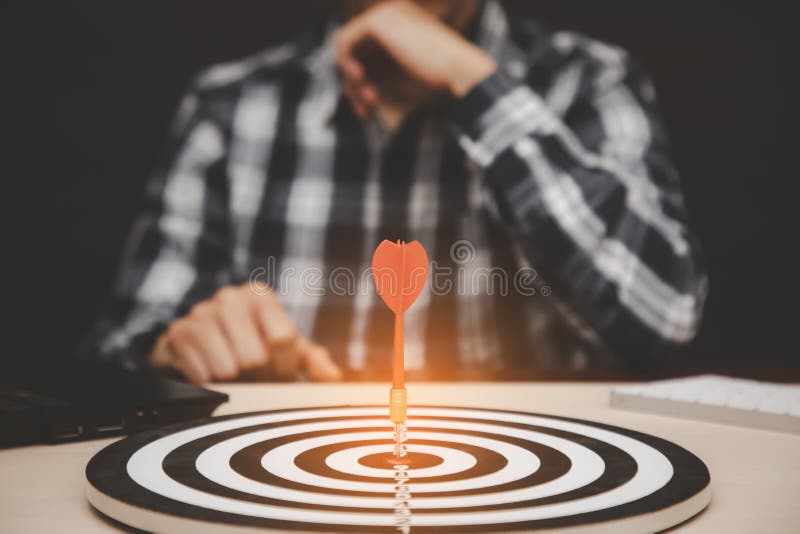 Targeting the business concept, Businessman showing thumbs up and look at red arrow dart to virtual target dart board,Executive ma stock photography