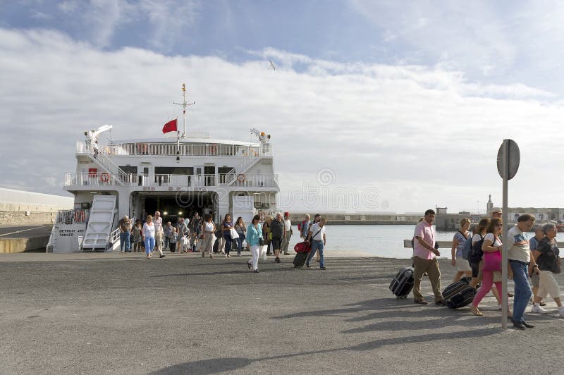 TARIFA, SPAIN, MARCH 18, 2019: Tourists descending from the ferry returning from Tangier, Morocco.