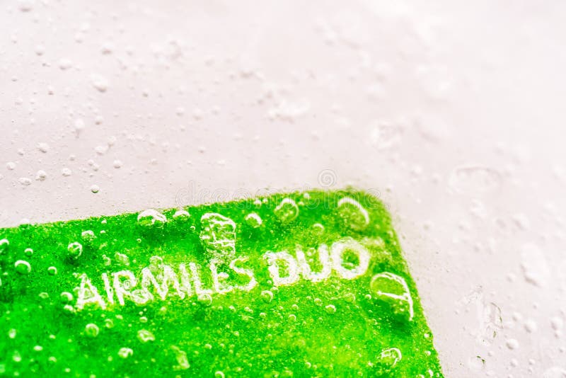 Tarjeta de débito congelada hielo del crédito del dúo de Airmiles de la opinión del primer foto de archivo Tarjeta de débito congelada hielo del crédito del dúo de Airmiles de la opinión del primer foto de archivo