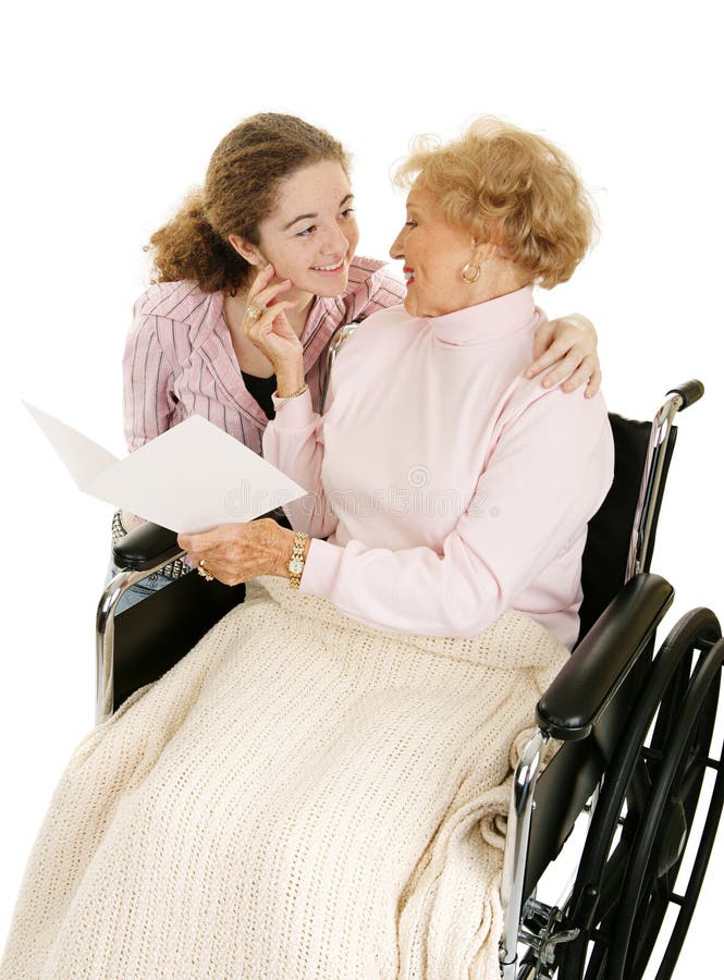 Grandmother receiving get well or mothers day card from granddaughter. Isolated on white. Grandmother receiving get well or mothers day card from granddaughter. Isolated on white.