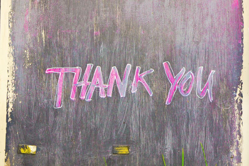 Thank you painted on a black wooden board. Thank you painted on a black wooden board