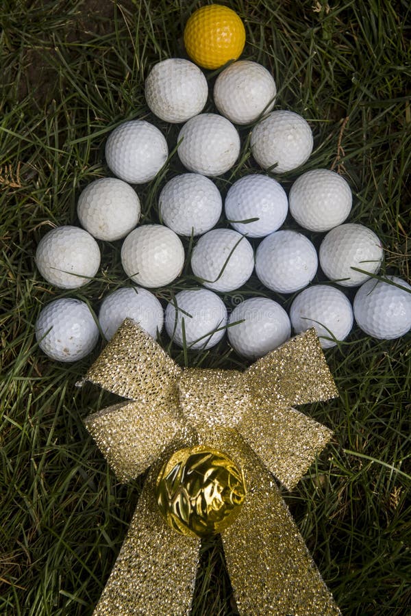 Christmas card simulating tree with golf balls on grass full sun. Christmas card simulating tree with golf balls on grass full sun