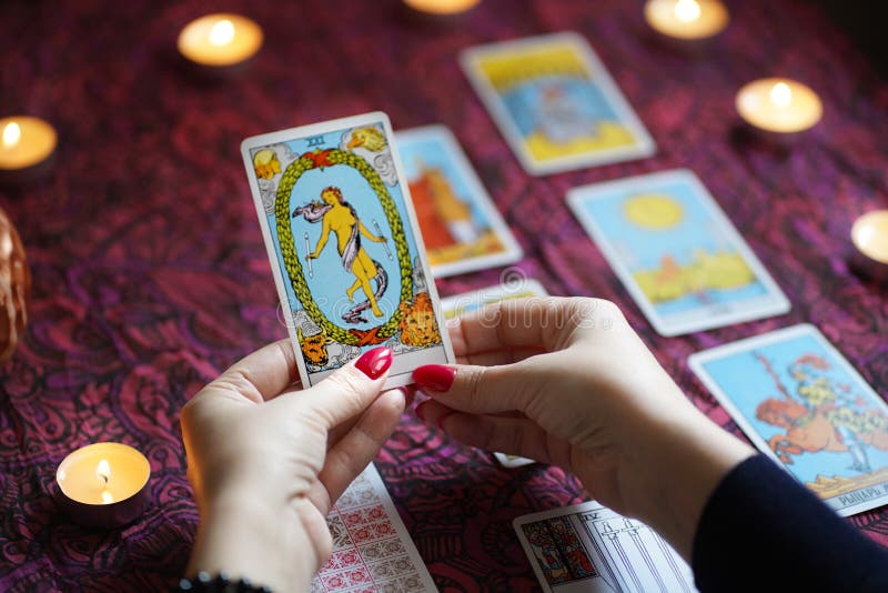 Tarot Reader Picking Tarot Cards.Tarot Cards On Table Near Burning ...