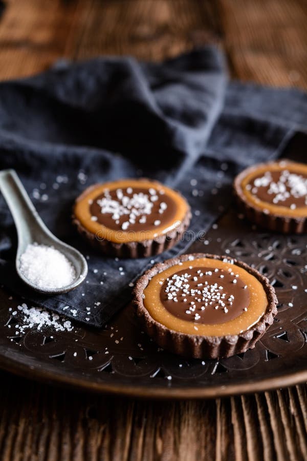 Tartlets del caramelo del chocolate tachonados con la sal fotografía de archivo Tartlets del caramelo del chocolate tachonados con la sal fotografía de archivo