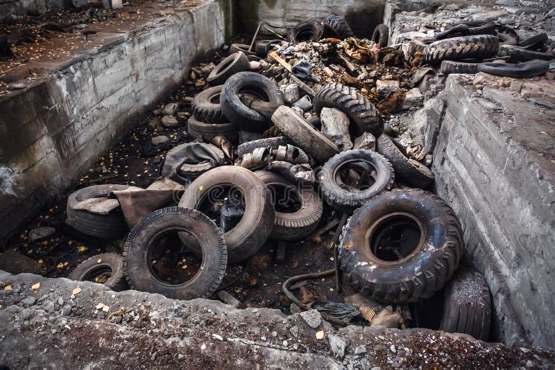 Tas de vieux pneus d'ordure de voiture, roues utilisées de déchets de camion, déchets industriels dans l'usine abandonnée photographie stock libre de droits Tas de vieux pneus d'ordure de voiture, roues utilisées de déchets de camion, déchets industriels dans l'usine abandonnée photographie stock libre de droits