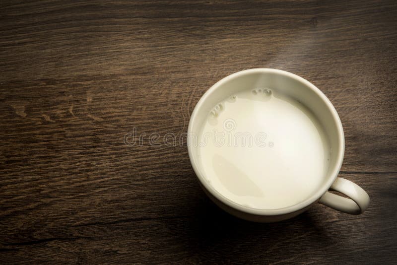 Delicious hot cup of milk , breakfast on old wooden table. Delicious hot cup of milk , breakfast on old wooden table
