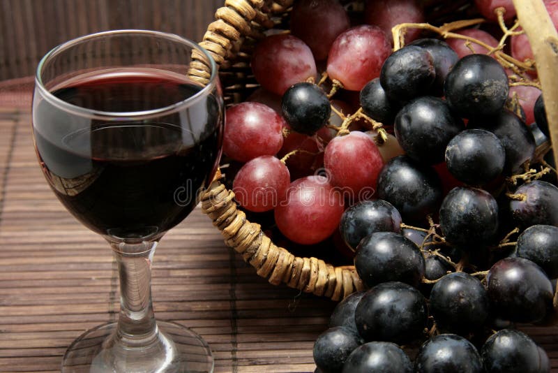 Tasting of grape and bottle of red wine