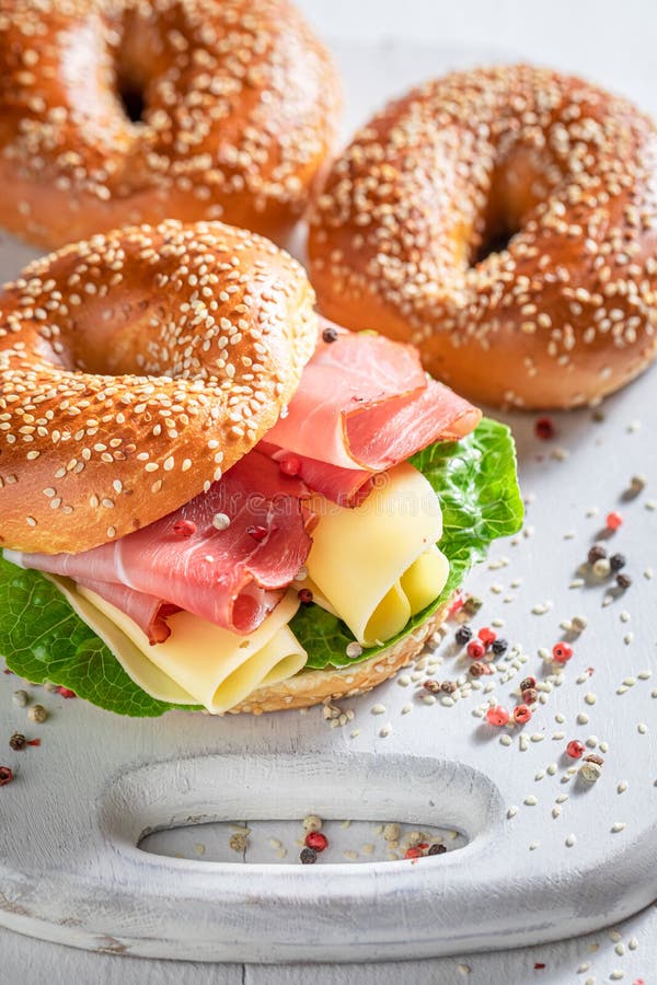 Tasty bagel with prosciutto and cheese for quick lunch