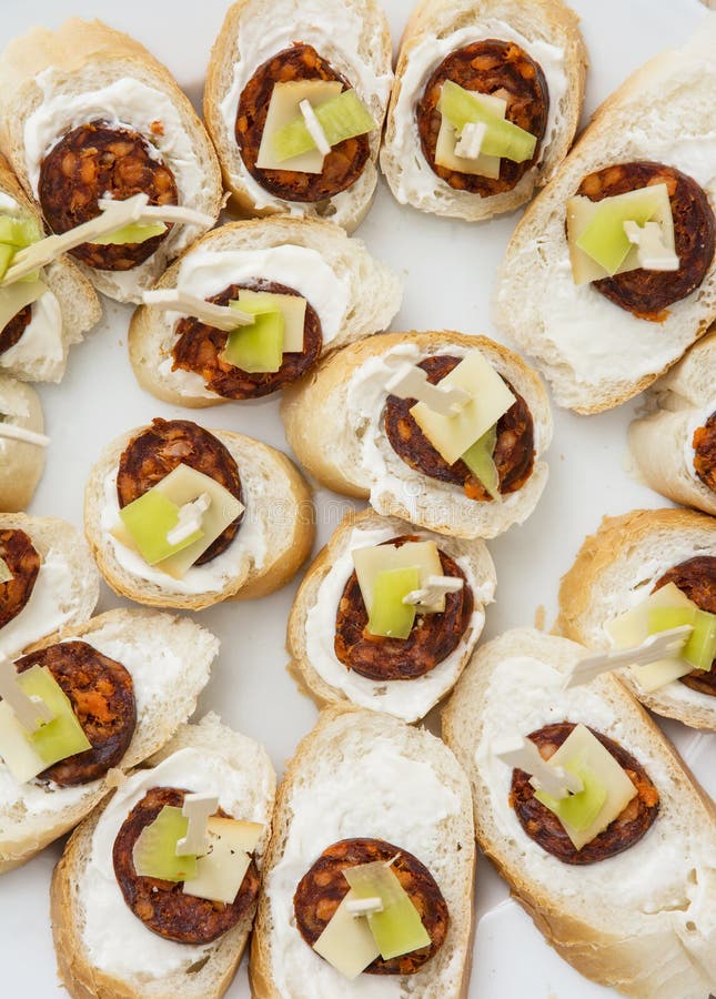 Tasty canapes with butter, sausage, cheese and paprika, refreshm