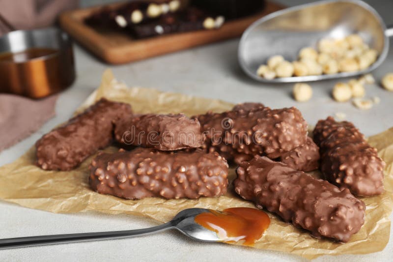 Tasty Chocolate Bars with Caramel on Light Table, Closeup Stock Image