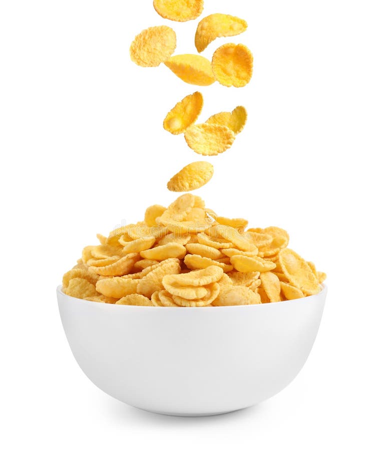 Tasty crispy corn flakes falling into bowl on background. Breakfast cereal