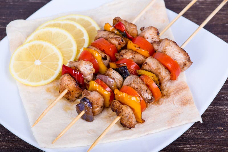 Tasty grilled meat and vegetables on skewer on plate. Roasted skewer grill stock images, royalty-free photos and pictures