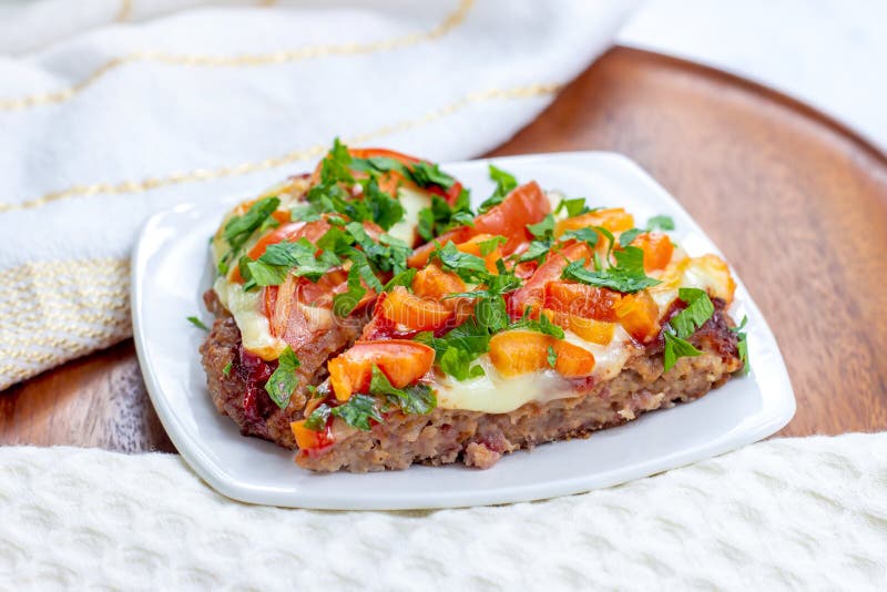 Tasty homemade Low-Carb Keto Meatza (grain and gluten free beef meat-based pizza) slice royalty free stock image Tasty homemade Low-Carb Keto Meatza (grain and gluten free beef meat-based pizza) slice royalty free stock image