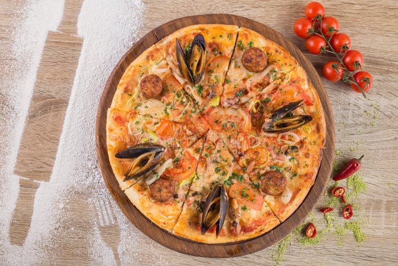 Tasty hot pizza with mussels and calamari