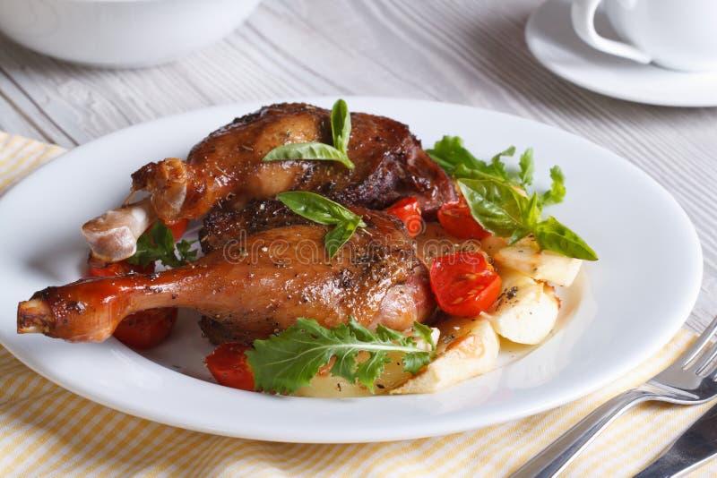 Tasty lunch: fried duck legs, with apples, tomatoes and herbs