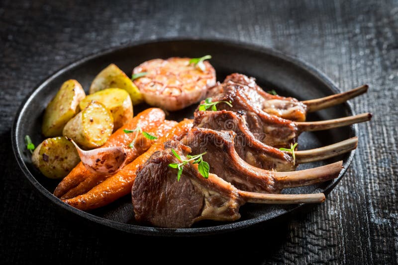 Tasty Roasted Lamb Ribs With Vegetables On Dark Background Stock Image