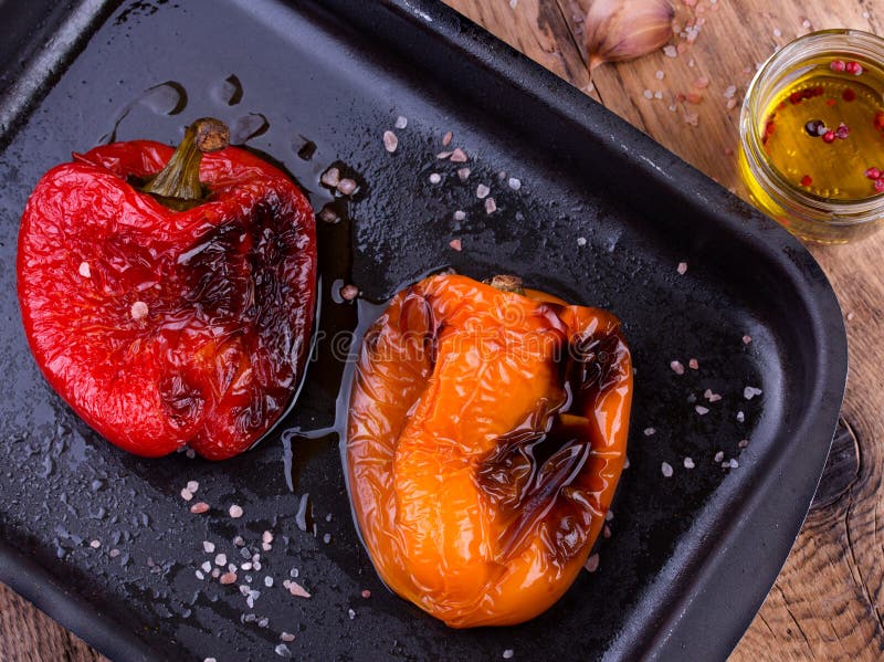 Tasty roasted red and orange bell peppers in pan