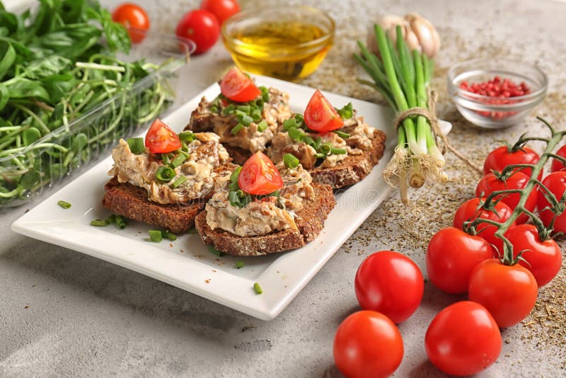 Tasty Sandwiches with Spread, Tomatoes and Herbs on Plate Stock Image