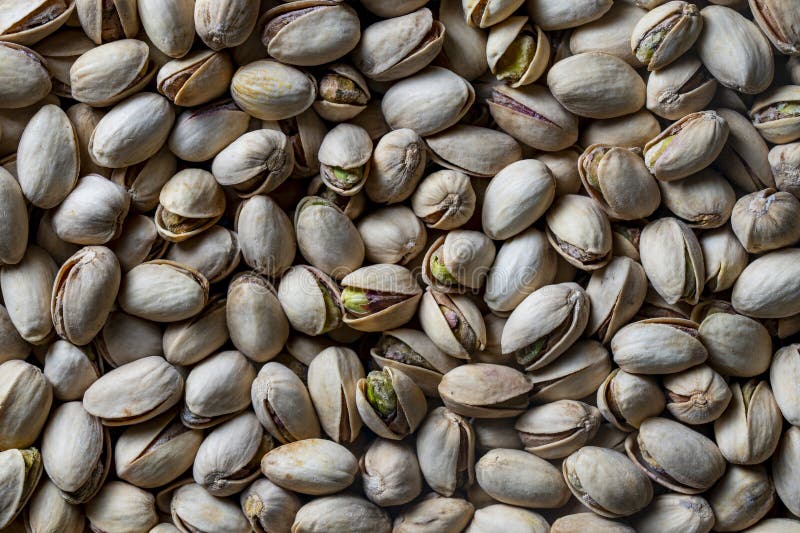 Tasty unpeeled pistachios , top view, closeup. Pistachios texture and background. Pile pistachio kernels nuts with shells stock photo
