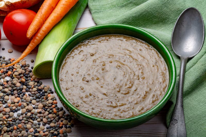Tasty vegetarian food, green bowl with lentils soup with vegetables, good for vegans royalty free stock photo Tasty vegetarian food, green bowl with lentils soup with vegetables, good for vegans royalty free stock photo