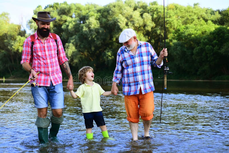 Dad and son fishing at lake. Young - adult concept. Men hobby. Grandfather, father and boy fishing together. Dad and son fishing at lake. Young - adult concept. Men hobby. Grandfather, father and boy fishing together