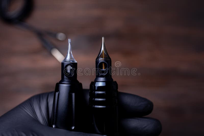 A Tattoo Artist Holds Two Tattoo Machines in His Hands Stock Image