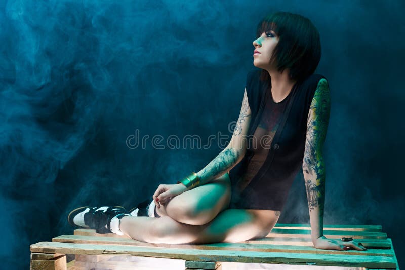 Tattooed girl in studio