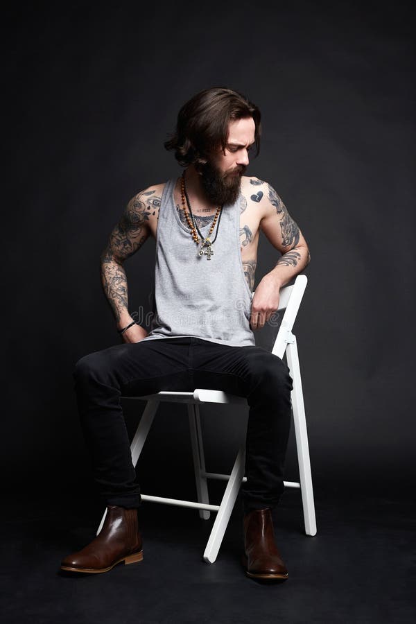 Tattooed Handsome Man Sitting on a Chair Stock Image - Image of dark ...