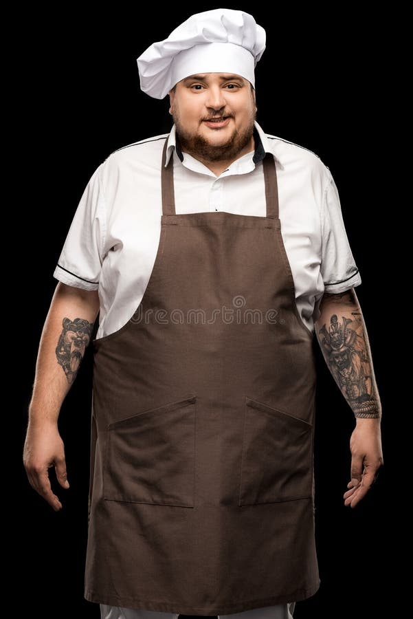 Tattooed Smiling Young Chef Standing In White Hat And Apron Stock Photo