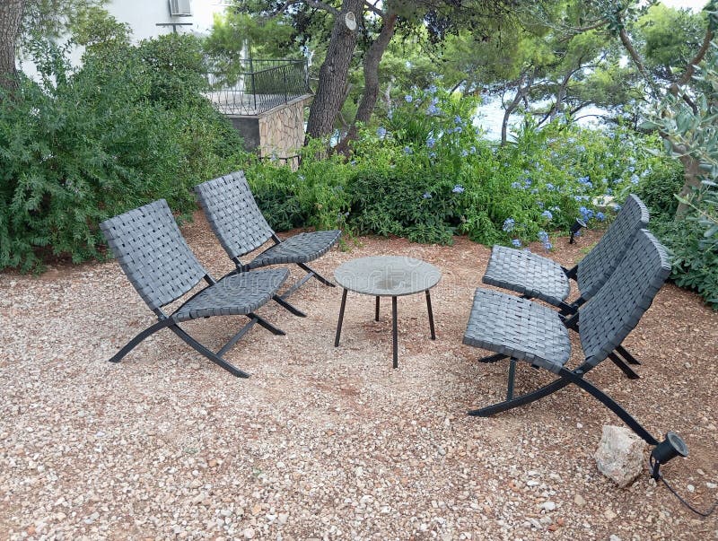 Outdoor, four chairs for all weather conditions and coffee table in aparthotel boulder courtyard. Outdoor, four chairs for all weather conditions and coffee table in aparthotel boulder courtyard