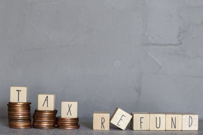 tax-refund-text-with-wooden-cubes-on-concrete-modern-background-texture