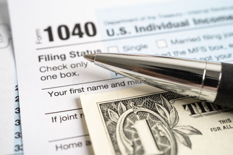 tax-return-form-1040-and-dollar-banknote-u-s-individual-income-stock