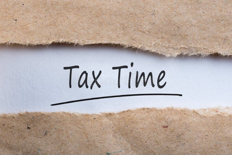 Tax time - inscription in a torn brown envelope. Notification of the need to file tax returns, message for accountant royalty free stock image