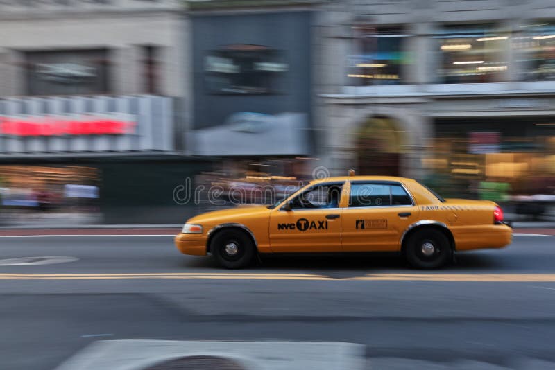 Taxi cab speeding through city stock photos