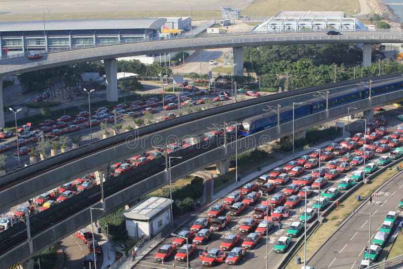 HONG KONG, 30 DECEMBER: the taxis queues in the hong kong international airport on 30 December 2013. Starting from December 8, 2013 onwards, taking a taxi will get more expensive by HK$2 per journey. HONG KONG, 30 DECEMBER: the taxis queues in the hong kong international airport on 30 December 2013. Starting from December 8, 2013 onwards, taking a taxi will get more expensive by HK$2 per journey