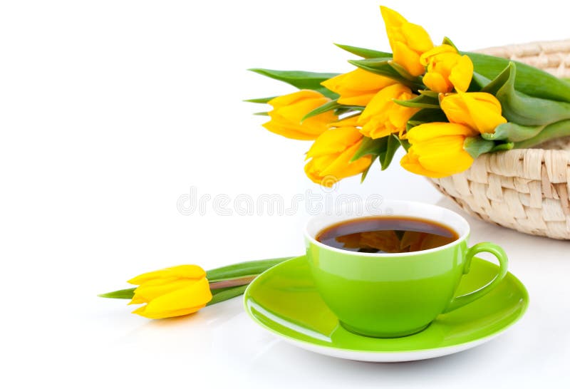 Coffee cup with yellow tulips, on white background. Coffee cup with yellow tulips, on white background.