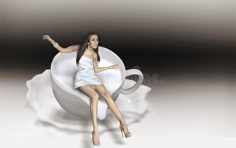 Dynamic photo of a young beauty in a cup of cappuccino. Dynamic photo of a young beauty in a cup of cappuccino