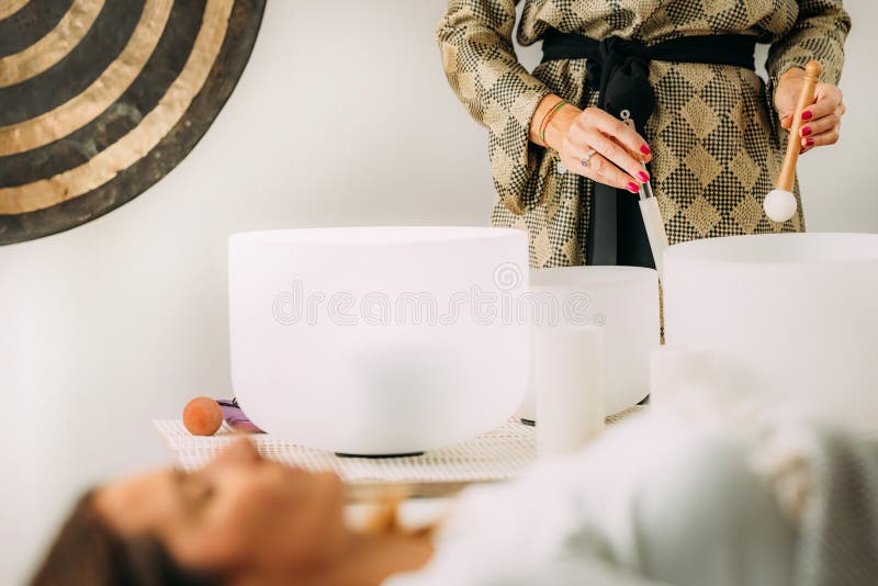 Crystal singing bowls in a sound healing therapy session. Crystal singing bowls in a sound healing therapy session