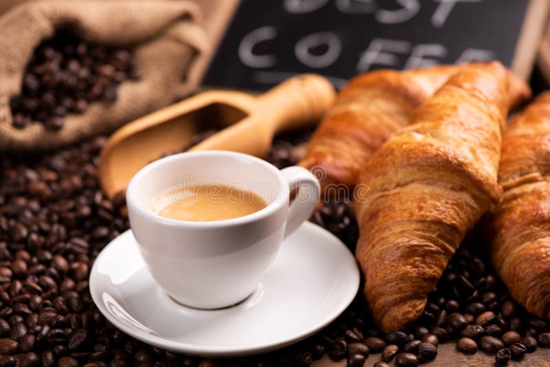 Tazza di caffè circondata dai chicchi di caffè fotografia stock libera da diritti Tazza di caffè circondata dai chicchi di caffè fotografia stock libera da diritti