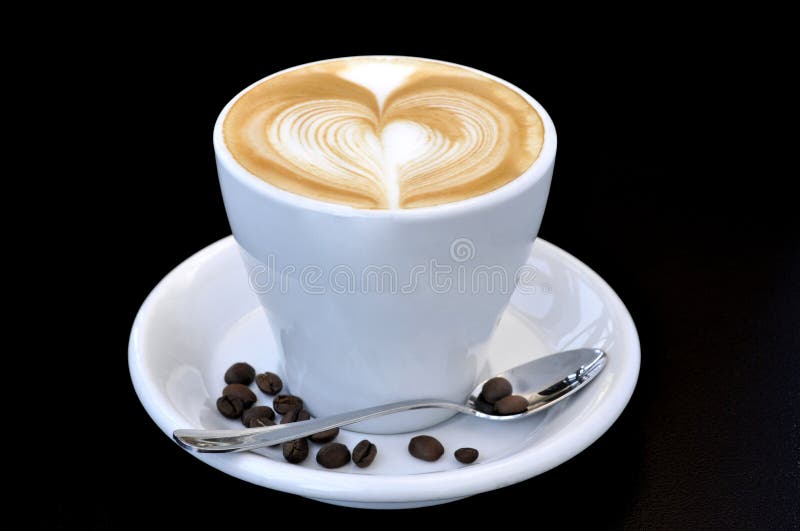 Close up of coffee cup with beans and heart on black background. Close up of coffee cup with beans and heart on black background